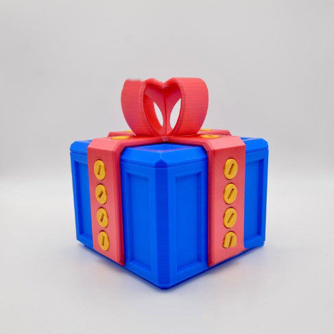 Blue annoying gift box gag present with red strap and yellow screw details by I Got It First