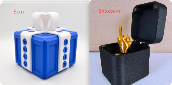Annoying gift box gag present by I Got It First with blue and white prank gift and black box with golden finger
