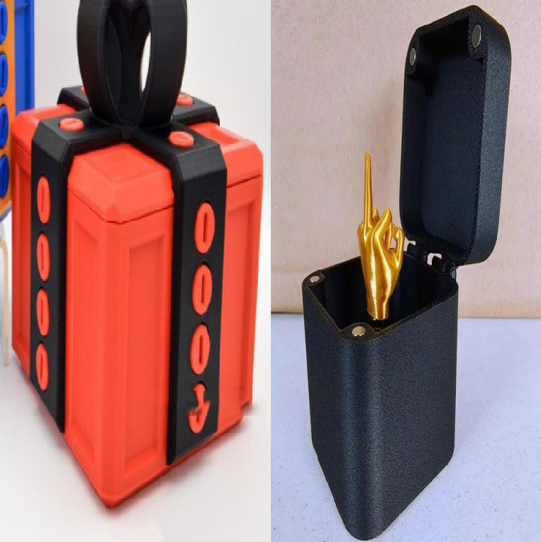 Annoying gift box gag present by I Got It First with a red box and a black container with a golden hand inside