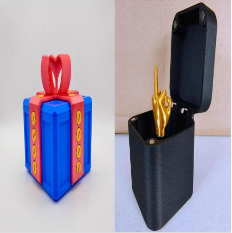 Annoying screw gift box gag present with blue gift box and black case featuring golden middle finger statue