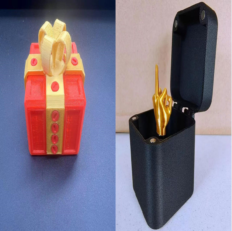 Annoying screw gift box gag present by I Got It First with red and gold gift design and black case with golden hand inside