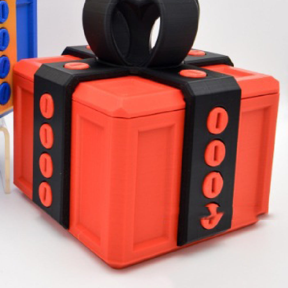 I Got It First annoying gift box gag present designed as a red box with black screw-themed bands